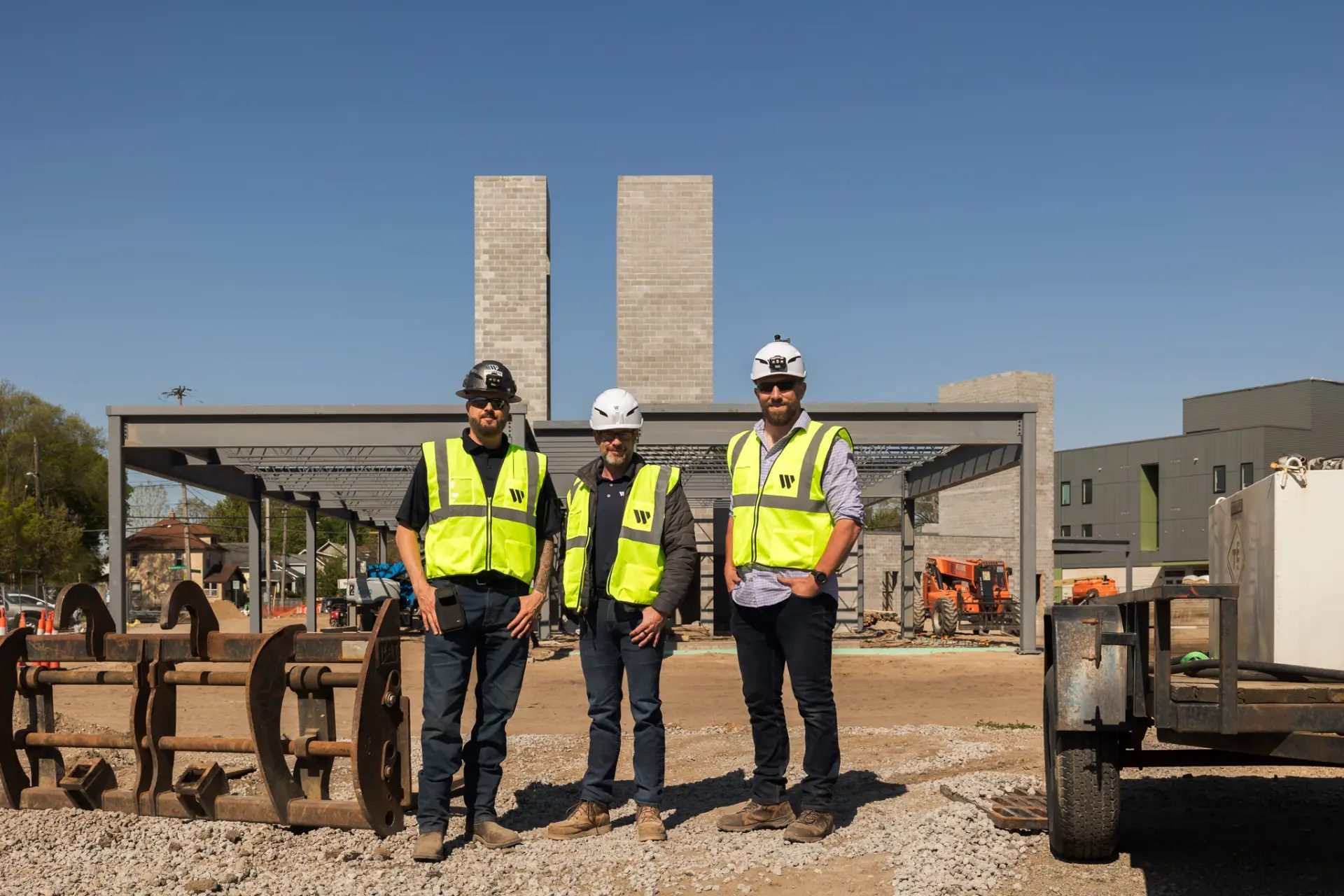 Wolverine Construction team members standing on the active Boston Square jobsite in Grand Rapids, Michigan.