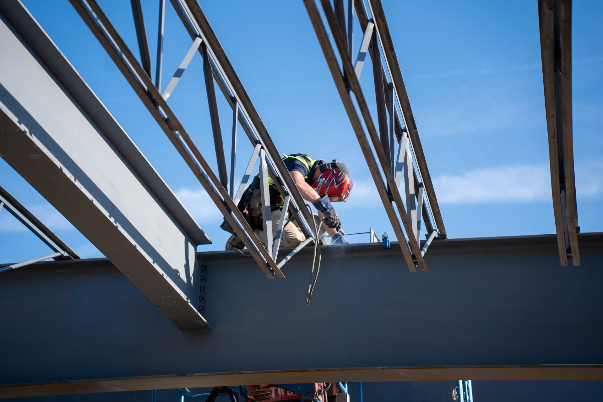 Wolverine Construction ironworker welding structural steel on an active jobsite.